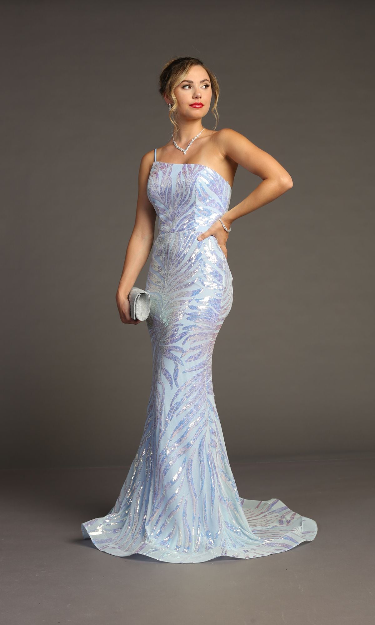 Woman in a Sequin-Print One-Shoulder Prom Dress: Chicas C823, holding a silver clutch and posing against a plain gray background—a dazzling option for any special occasion or formal event.